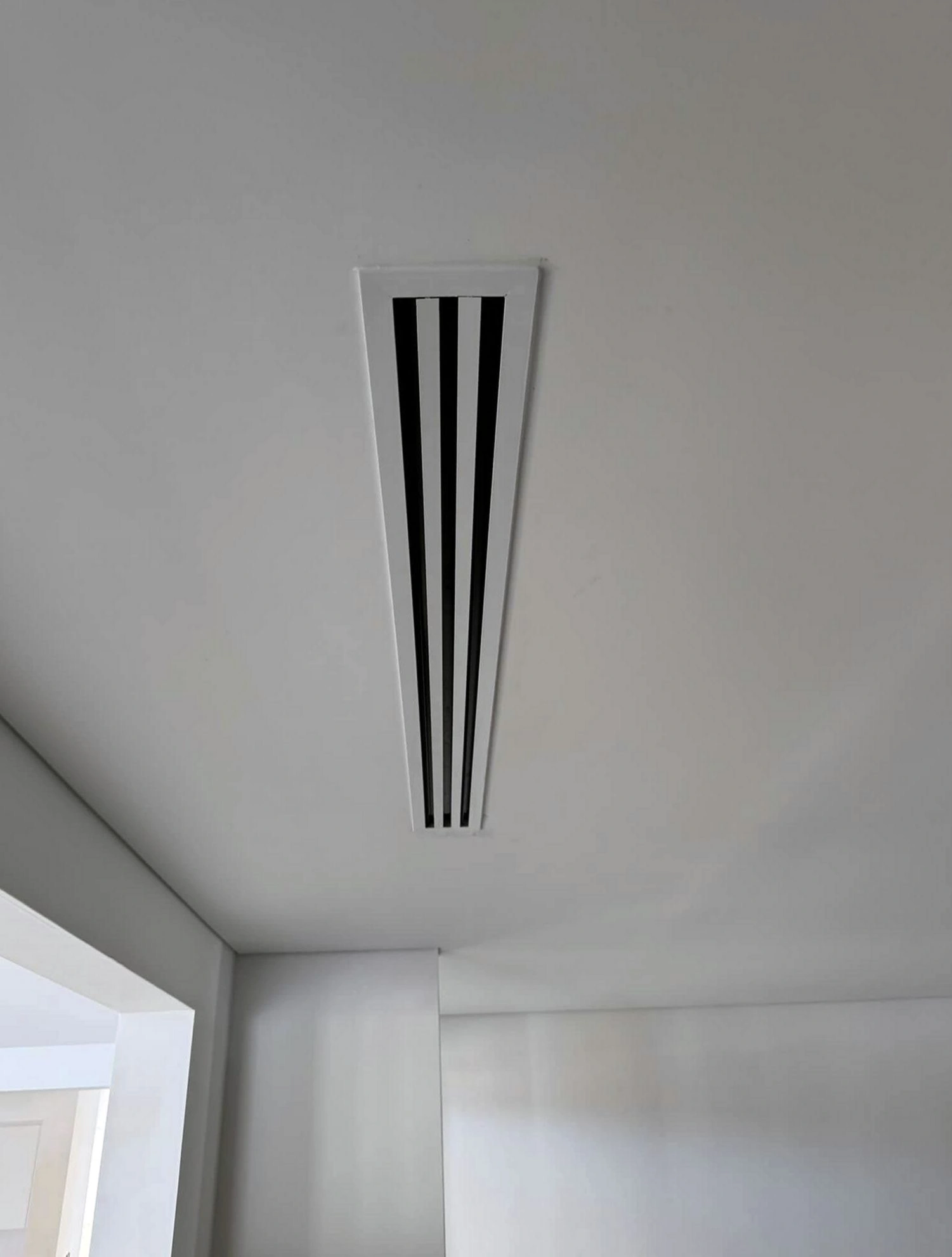 HVAC technician installing a residential furnace unit in a Detroit home